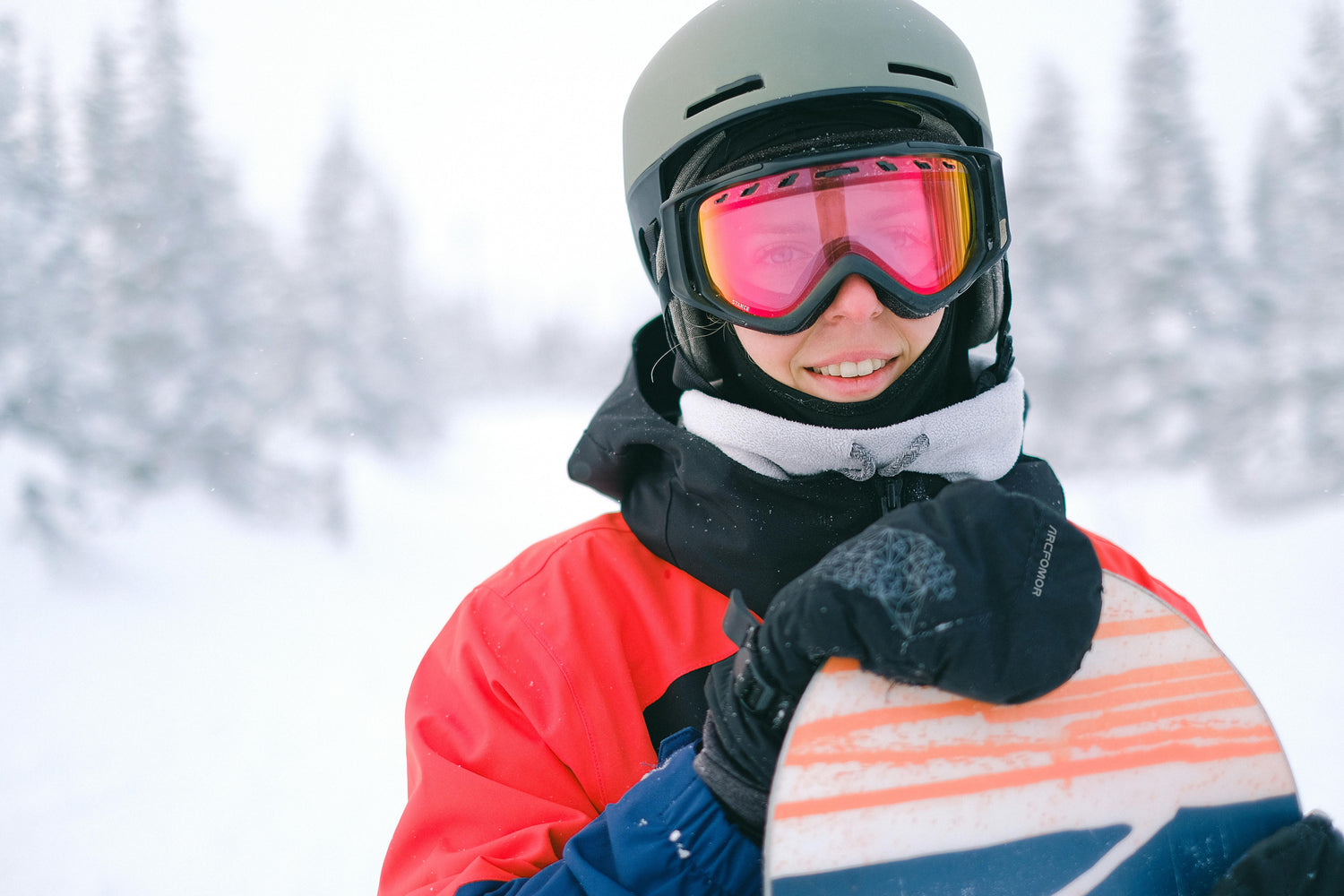 A woman in cold winter weather, wearing Arcfomor heated gloves, relishing the warmth and comfort they provide.