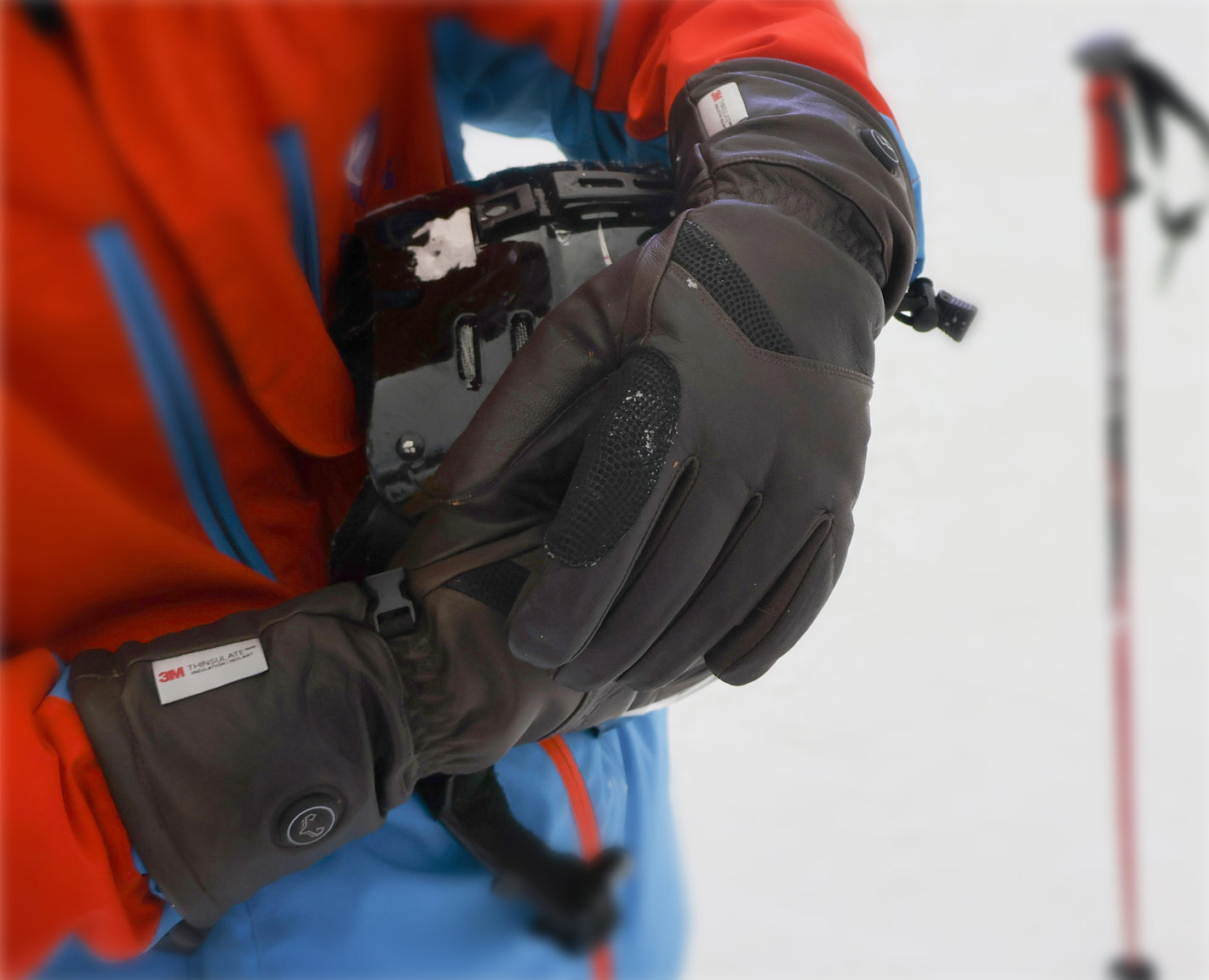 A man skiing happily wearing Vellum heated gloves