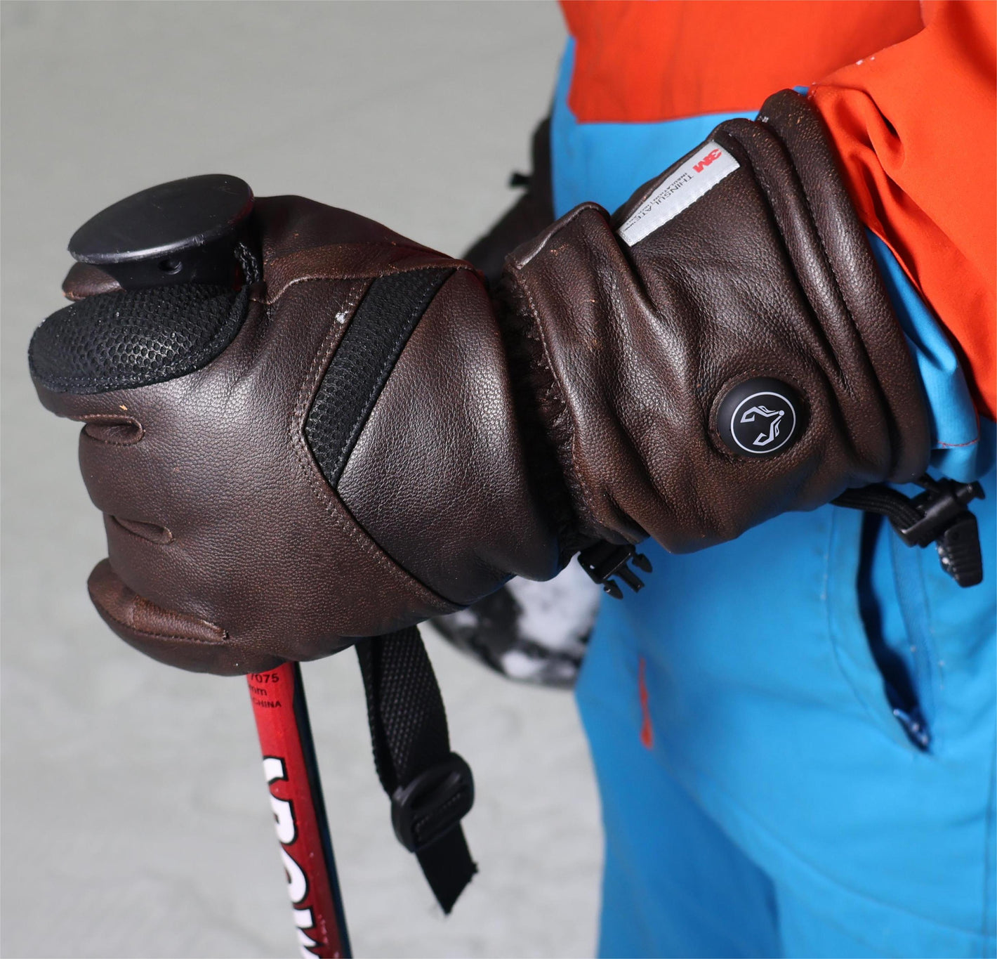 A man skiing happily wearing Vellum heated gloves