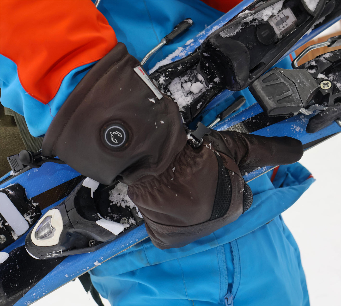 A man skiing happily wearing Vellum heated gloves